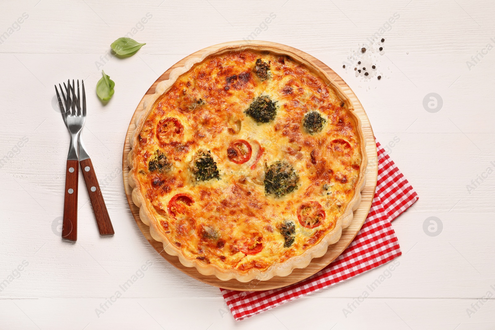Photo of Delicious homemade vegetable quiche and forks on wooden table, flat lay