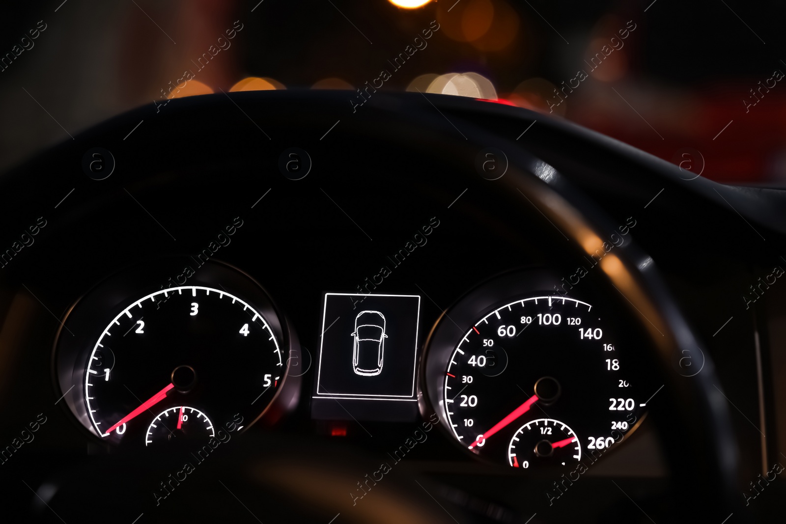 Photo of Closeup view of dashboard with speedometer and tachometer in modern car
