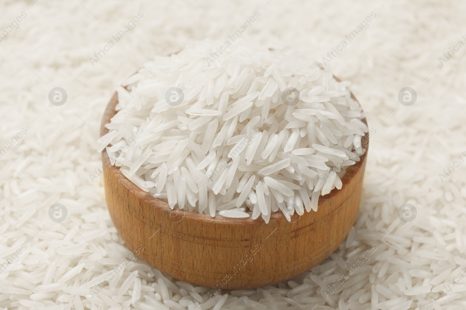 Photo of Bowl on raw basmati rice, closeup view