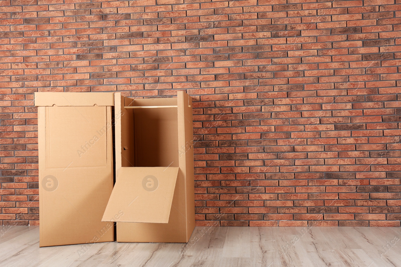 Photo of Wardrobe boxes against brick wall indoors. Space for text