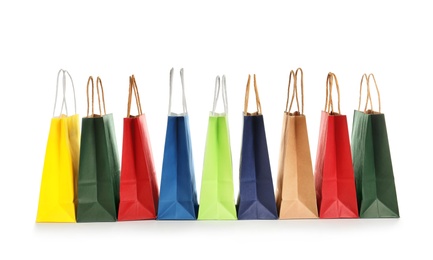 Photo of Colorful paper shopping bags on white background