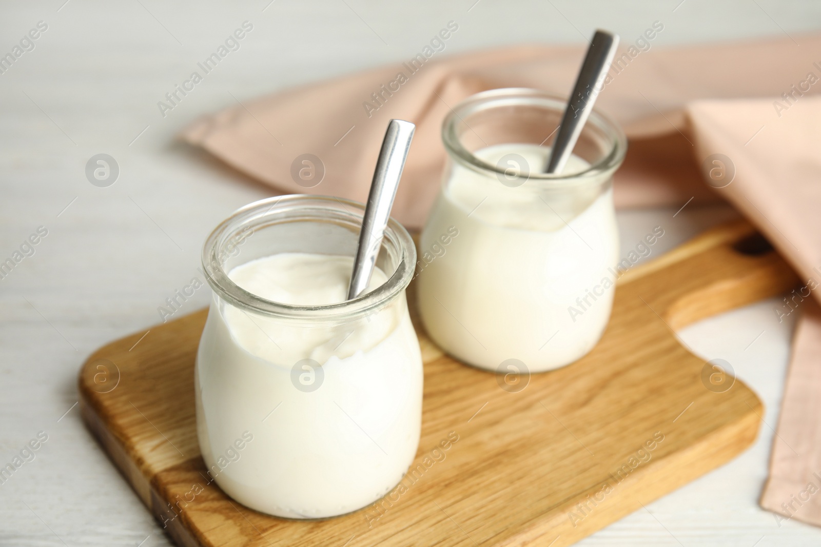 Photo of Tasty organic yogurt on white wooden table