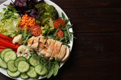 Photo of Balanced diet and healthy foods. Plate with different delicious products on wooden table, top view. Space for text