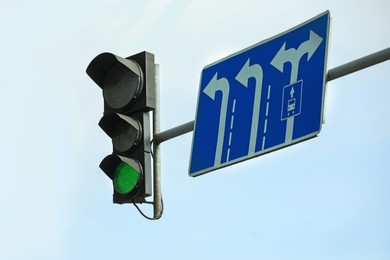Photo of Traffic light against blue sky in city