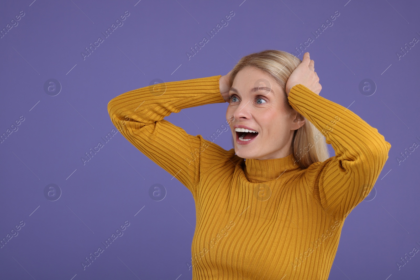 Photo of Portrait of surprised woman on violet background, space for text