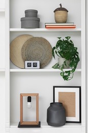 Photo of Shelves with different decor indoors. Interior design