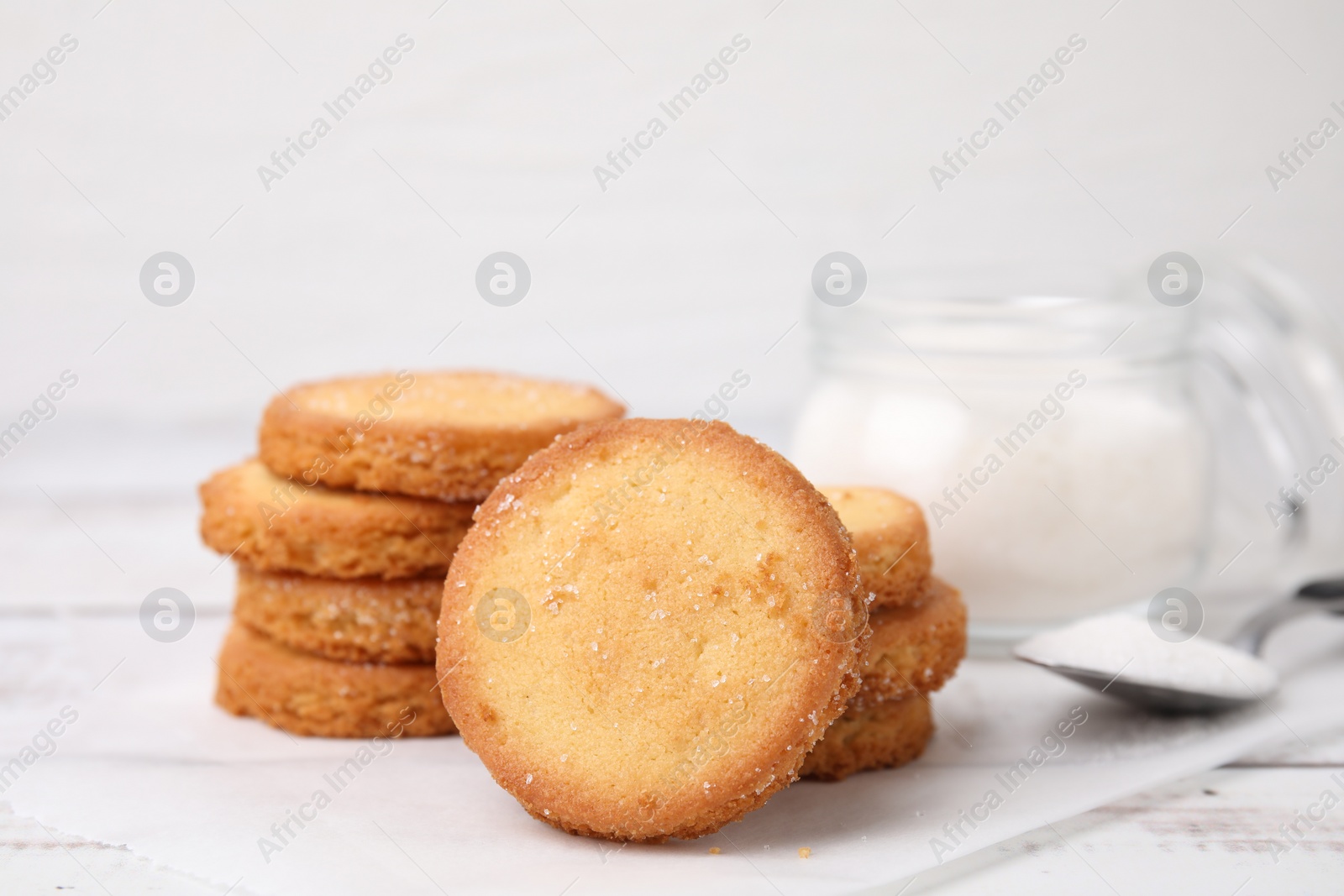 Photo of Tasty sweet sugar cookies on white wooden table, closeup