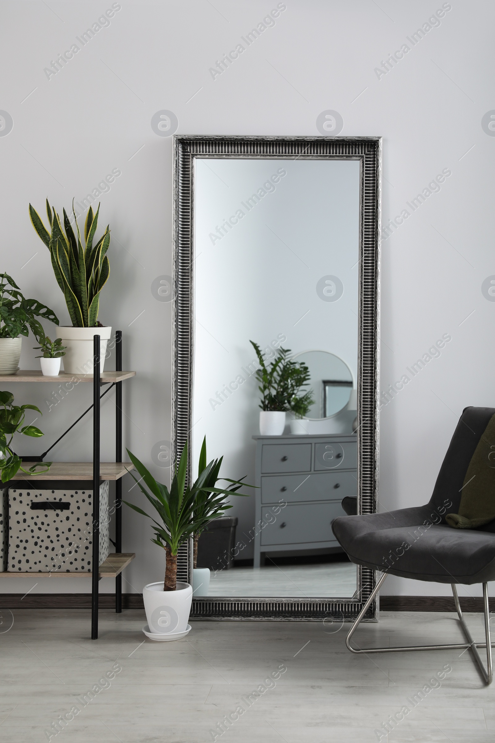 Photo of Stylish room interior with leaning floor mirror