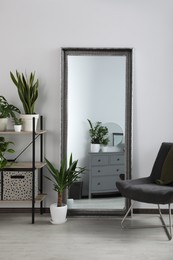 Photo of Stylish room interior with leaning floor mirror