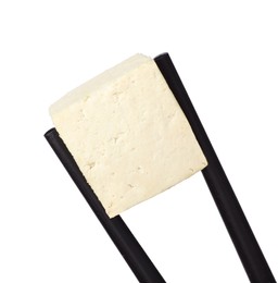 Photo of Chopsticks with delicious raw tofu cube isolated on white