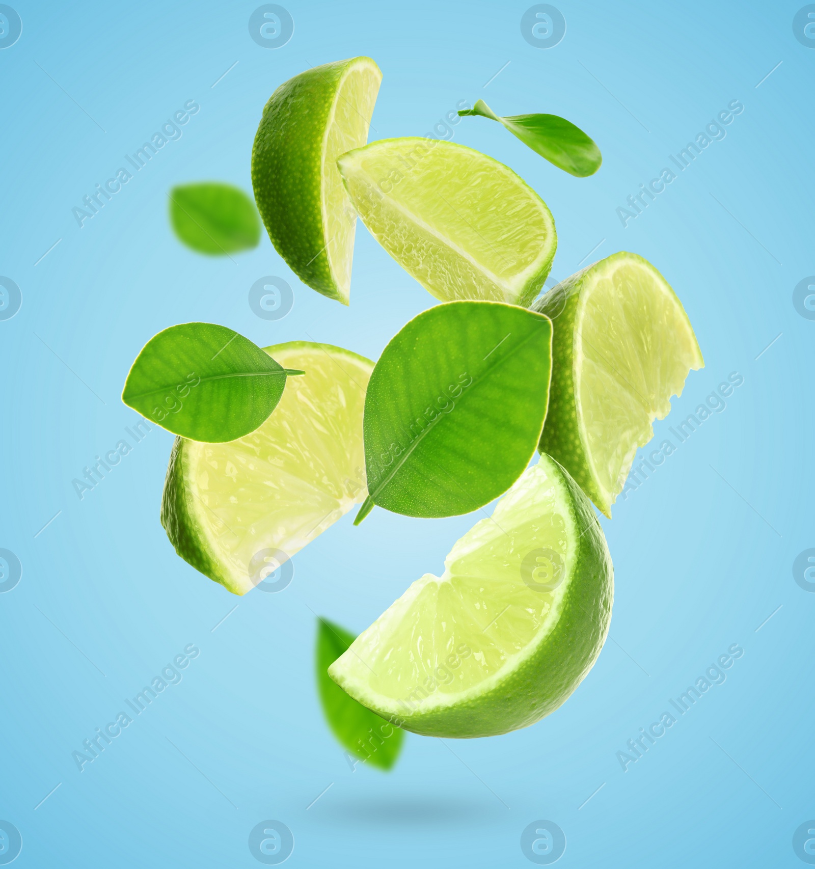 Image of Fresh lime slices and green leaves falling on light blue background