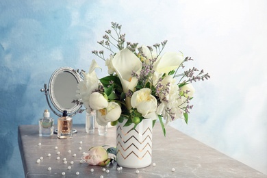 Vase with bouquet of beautiful flowers on table