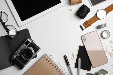 Photo of Flat lay composition with vintage camera, smartphone and tablet on white table, space for text. Designer's workplace