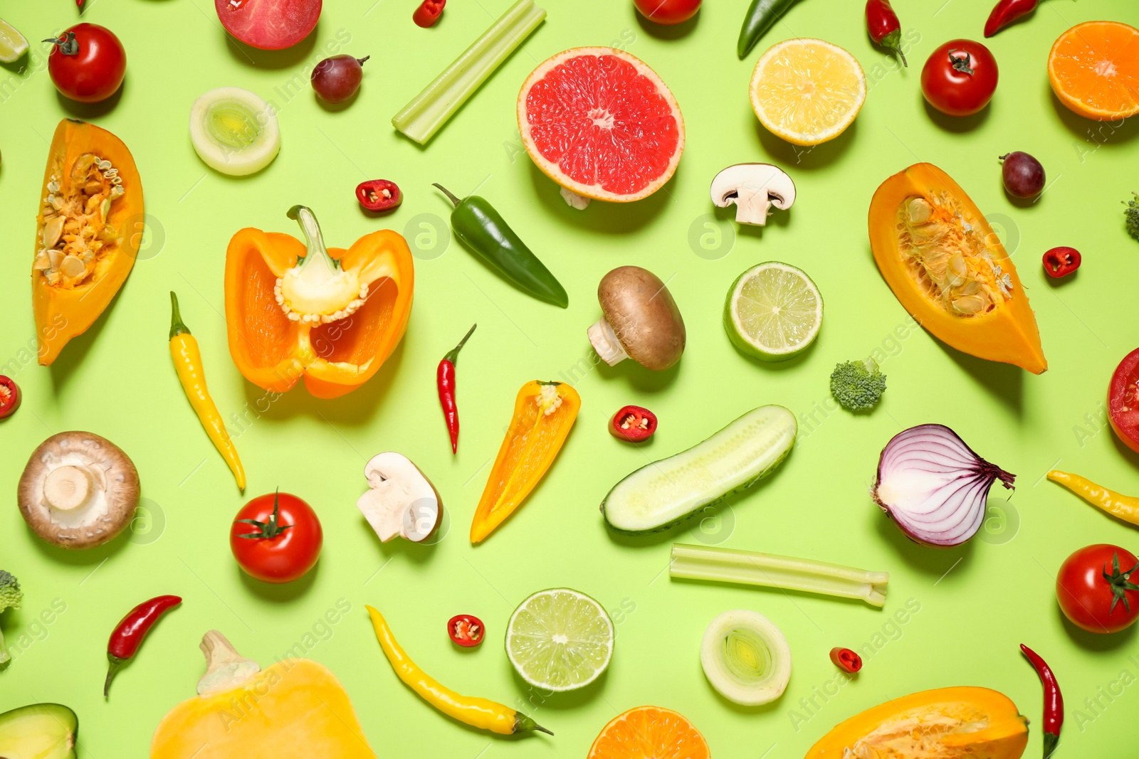 Photo of Flat lay composition with fresh organic fruits and vegetables on light green background