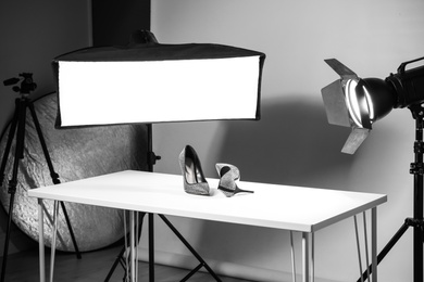 Photo of Professional photography equipment prepared for shooting stylish shoes in studio