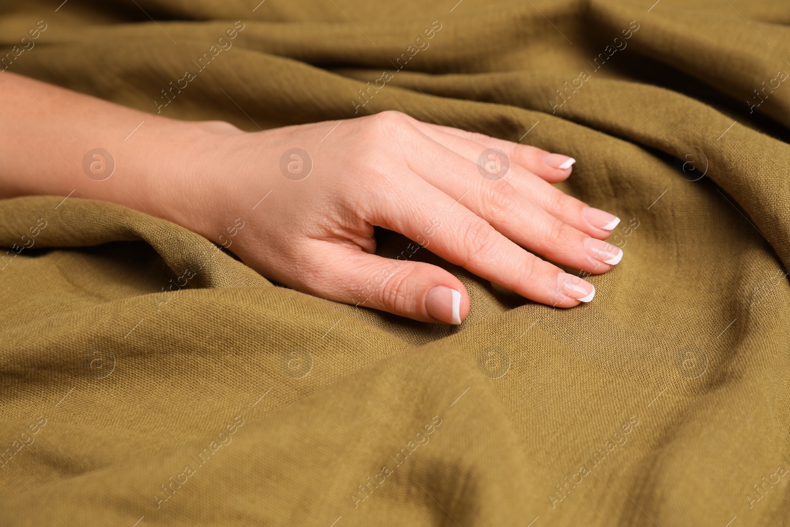 Photo of Woman touching soft linen fabric, closeup view