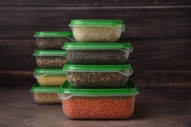 Plastic containers filled with food products on brown table