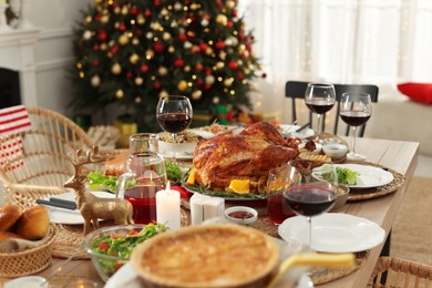 Festive dinner with delicious baked turkey served on table indoors. Christmas celebration