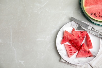 Photo of Yummy watermelon slices on grey table, flat lay. Space for text