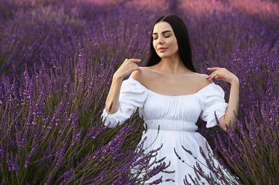 Photo of Portrait of beautiful young woman in lavender field