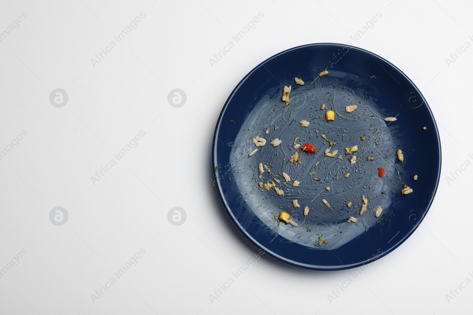 Photo of Dirty plate with food leftovers on white background, top view