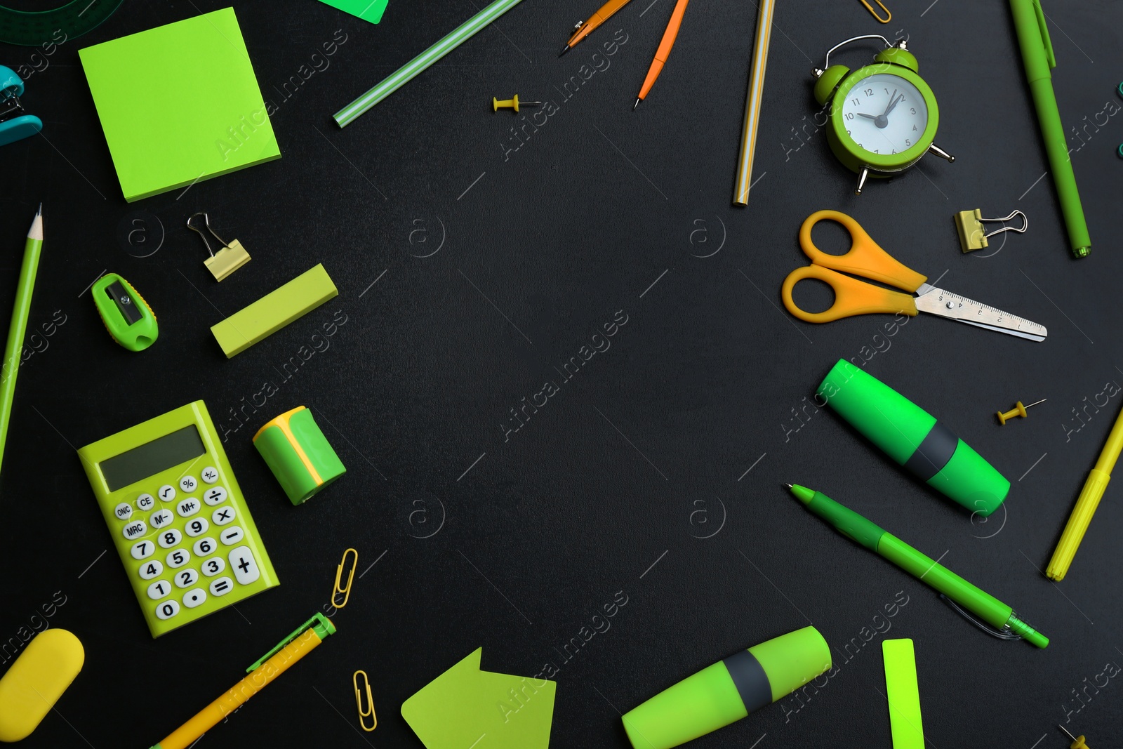 Photo of Frame of different bright school stationery on black background, flat lay. Space for text