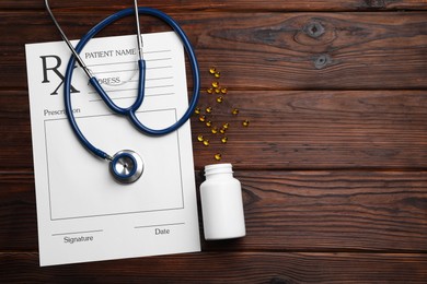 Medical prescription form with empty fields, stethoscope and pills on wooden table, flat lay. Space for text