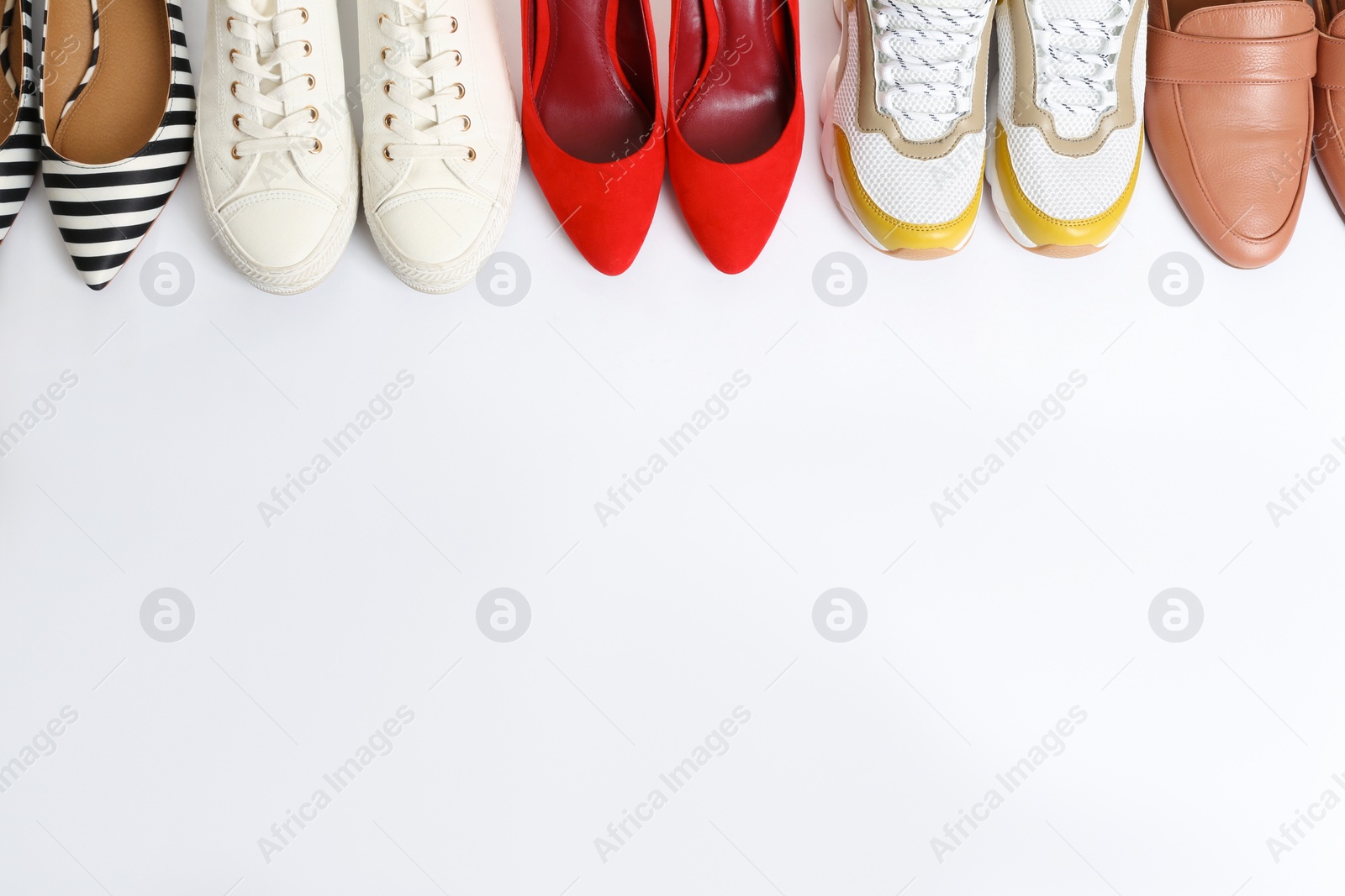 Photo of Different shoes on white background, top view