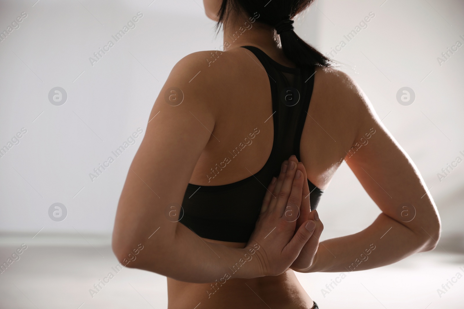 Photo of Young woman practicing seiza asana in yoga studio, closeup. Vajrasana pose