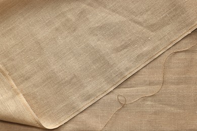 Texture of burlap fabric as background, top view