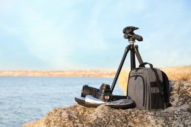 Photo of Professional photography equipment on rocky river coast