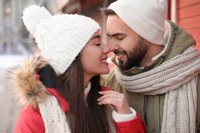 Photo of Happy young couple spending time together at winter fair. Christmas celebration