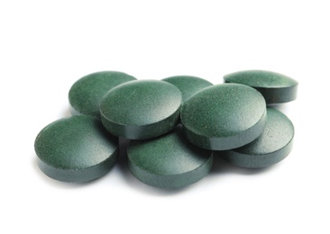 Photo of Spirulina tablets on white background. Healthy lifestyle