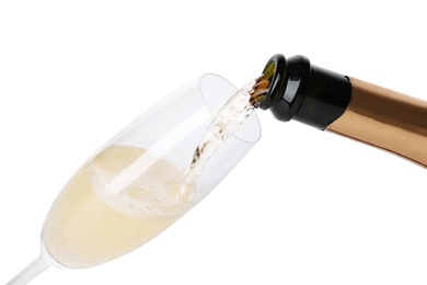 Photo of Champagne pouring from bottle into glass isolated on white