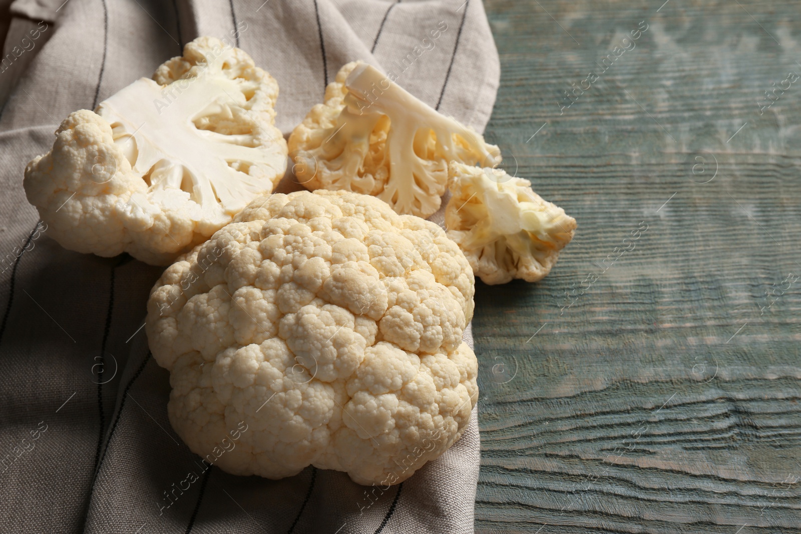 Photo of Fresh raw cauliflower on light blue wooden table