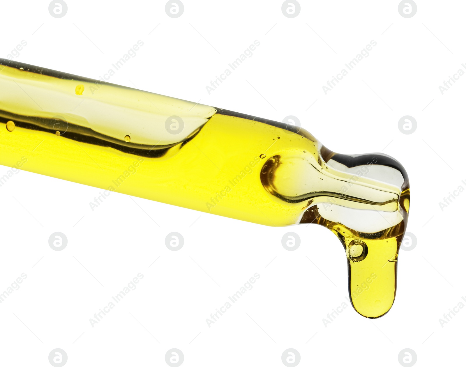 Photo of Dripping yellow facial serum from pipette on white background, closeup