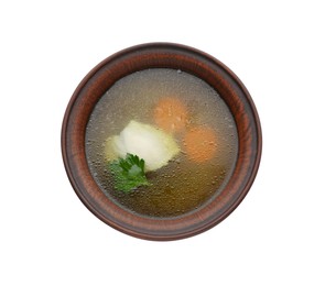 Delicious chicken bouillon with carrot and parsley in bowl on white background, top view