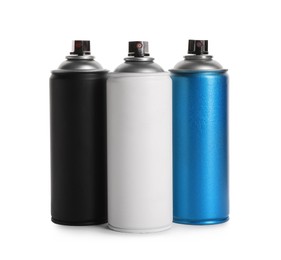 Photo of Cans of different spray paints on white background. Graffiti supplies