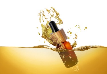 Image of Bottle of cosmetic product falling into essential oil against white background