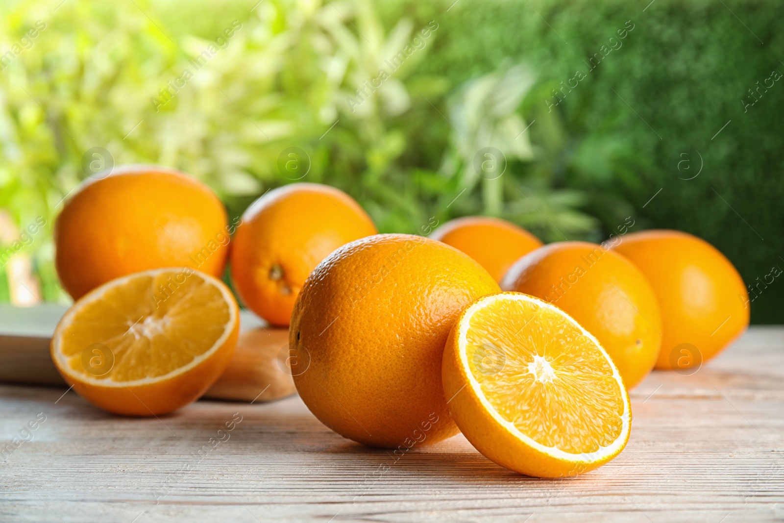 Photo of Fresh juicy oranges on wooden table. Healthy fruits