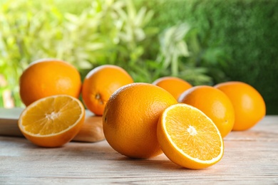 Fresh juicy oranges on wooden table. Healthy fruits