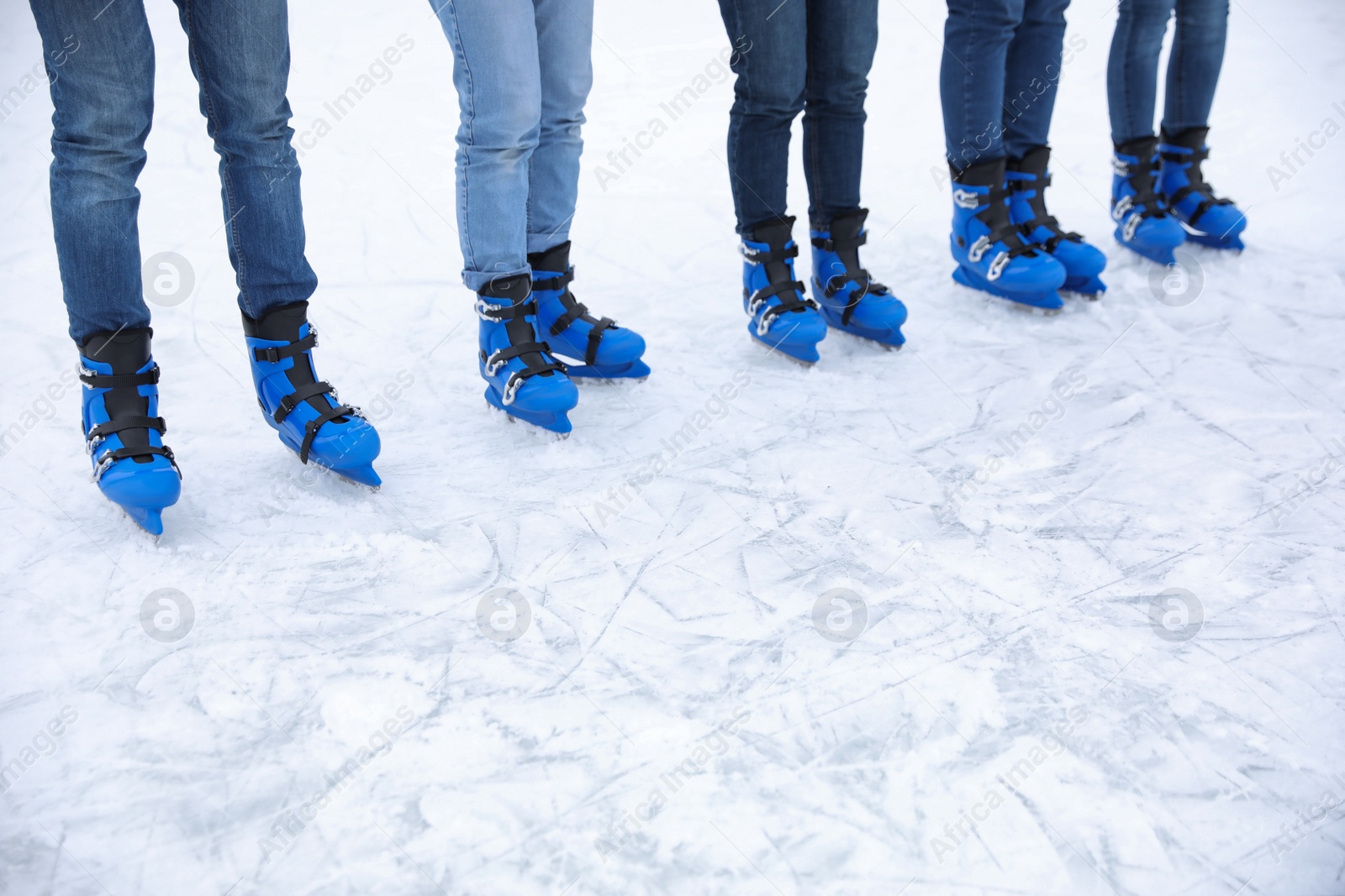 Photo of Friends at ice skating rink outdoors, closeup. Space for text