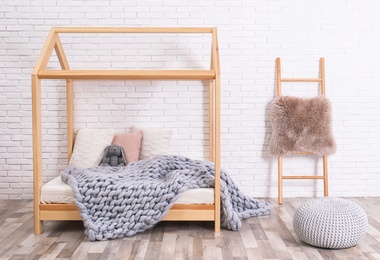 Photo of Stylish child room interior with house bed