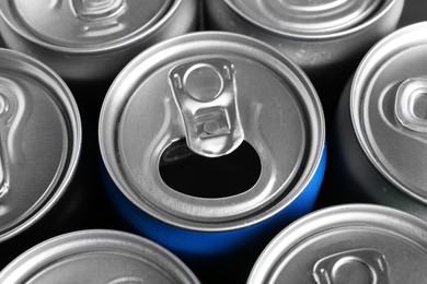 Energy drinks in cans as background, closeup. Functional beverage
