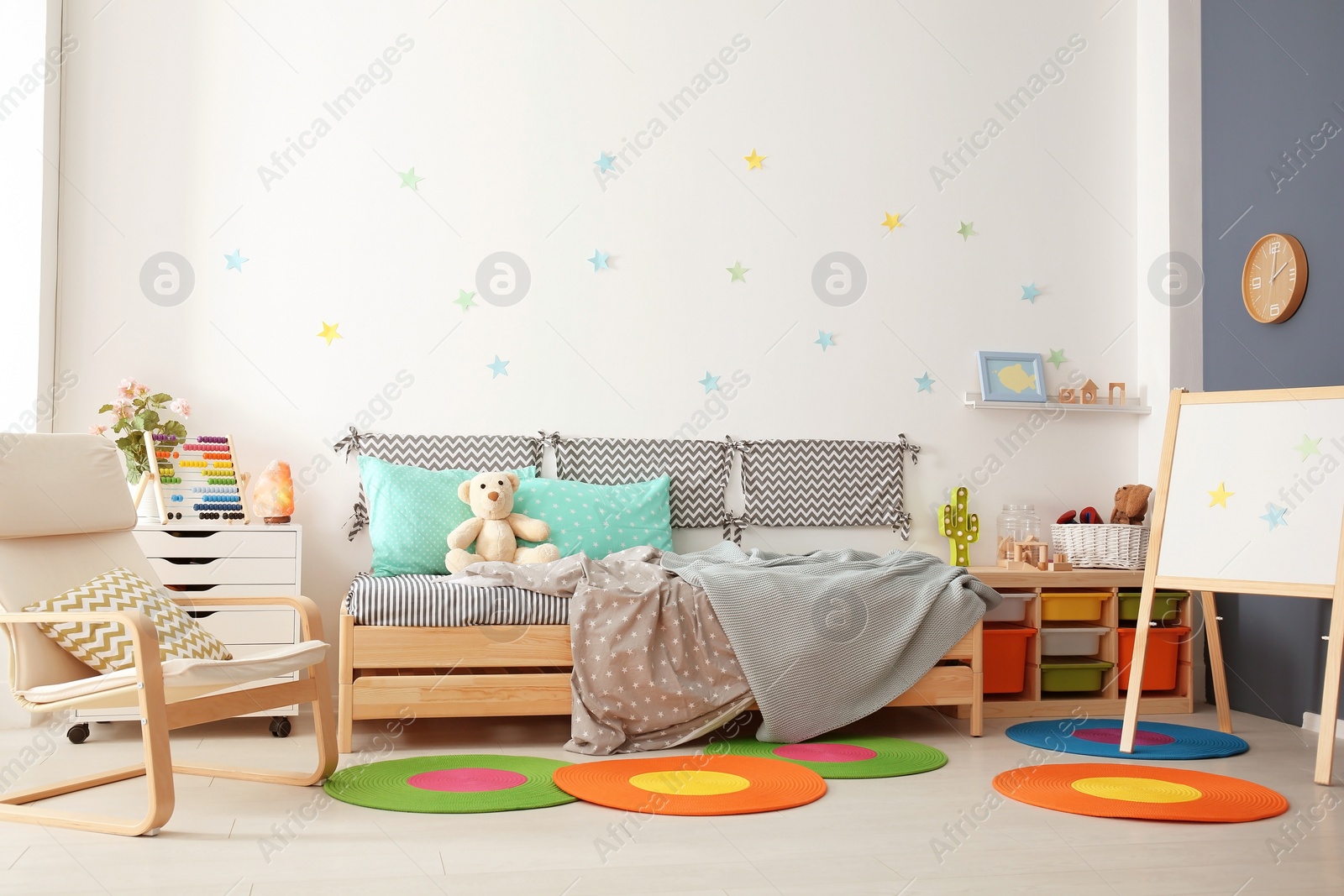 Photo of Modern child room interior with comfortable bed and armchair