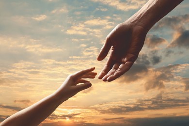 Image of Godparent with child and beautiful sky with clouds at sunset on background, closeup