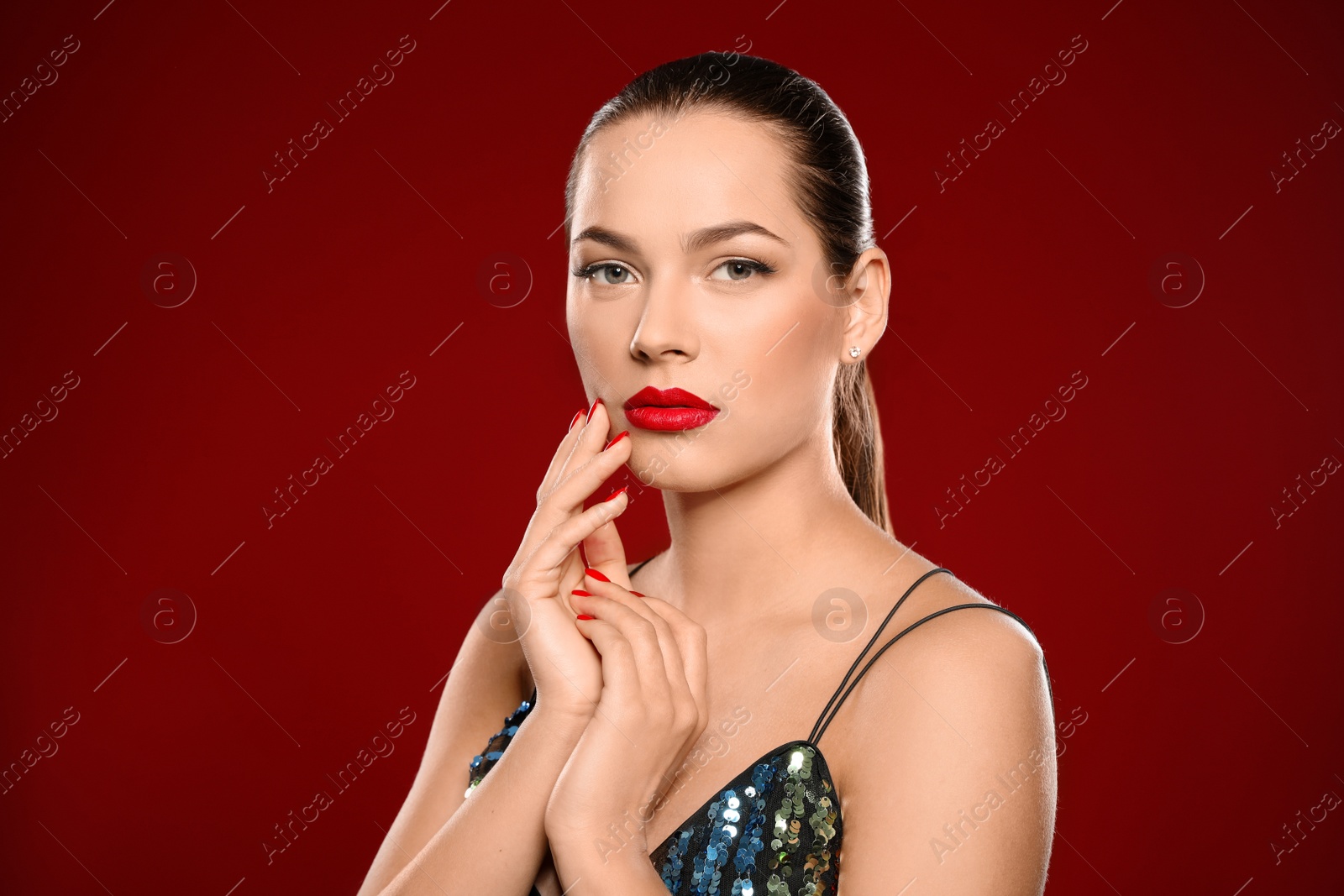 Photo of Portrait of beautiful young woman with bright manicure on color background. Nail polish trends