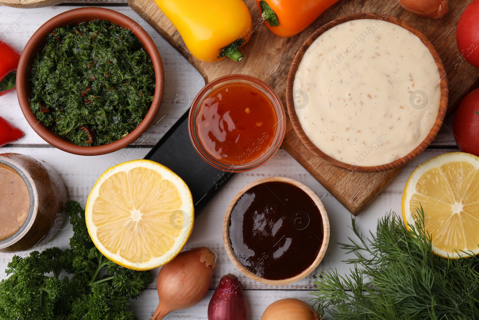 Photo of Different fresh marinades and ingredients on white wooden table, flat lay