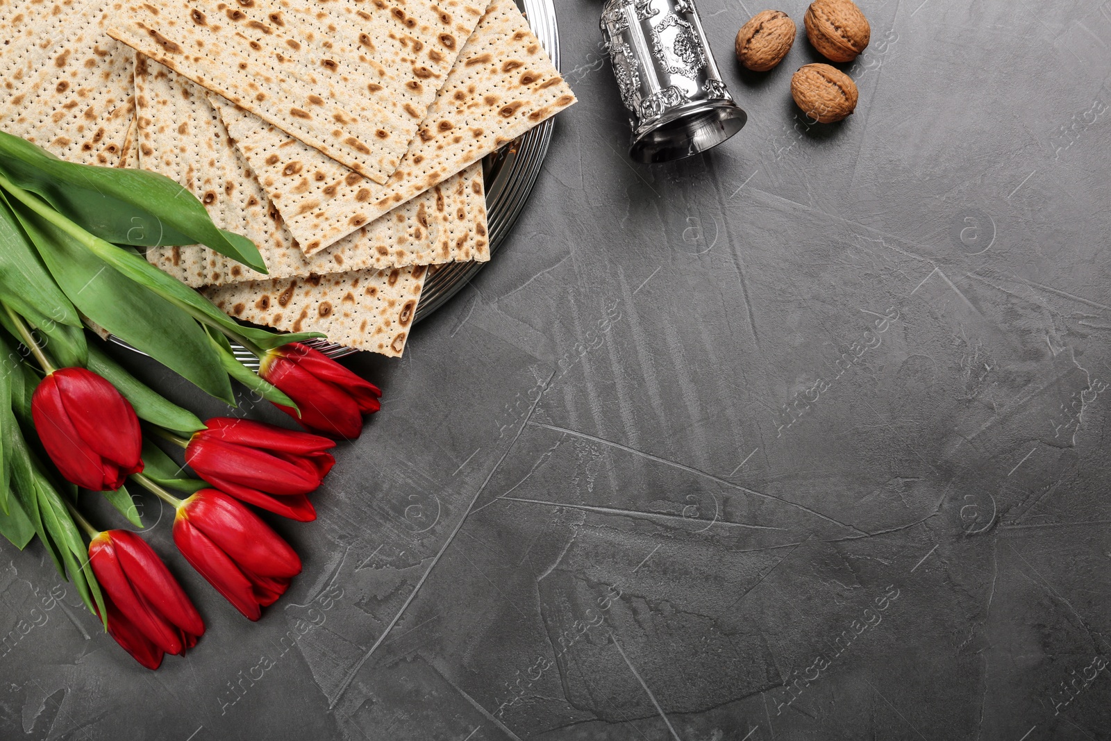 Photo of Flat lay composition with matzos on dark background, space for text. Passover (Pesach) celebration