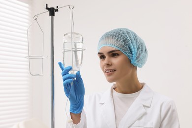 Nurse setting up IV drip in hospital